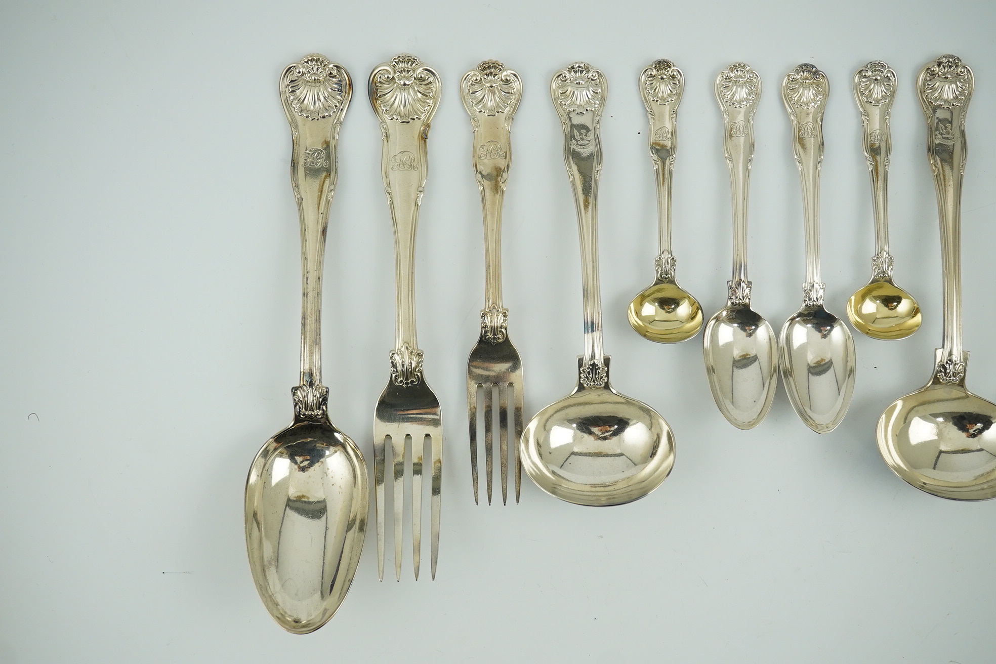 A matched part canteen of George IV and later silver shell scroll pattern flatware